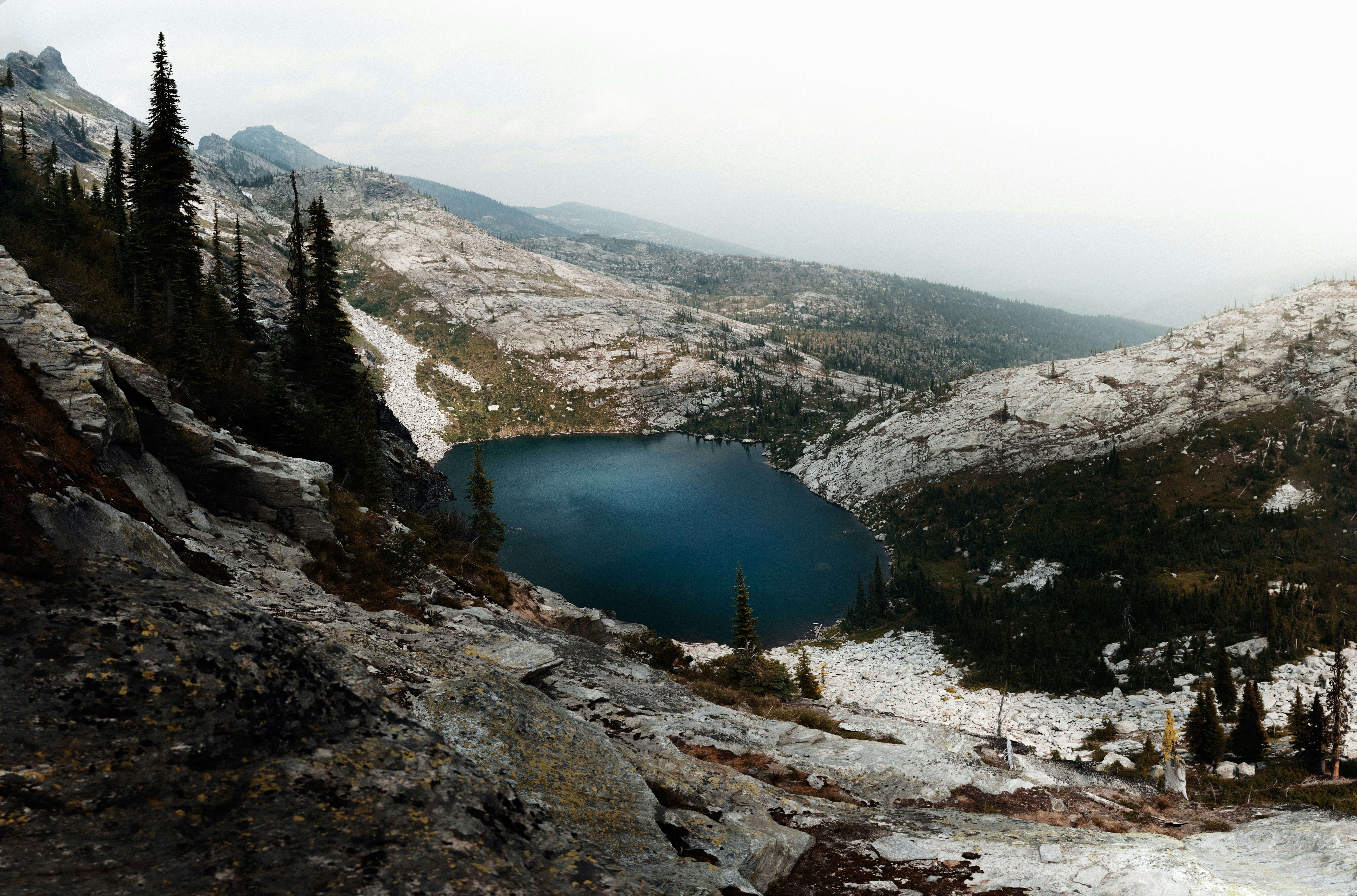 lake in the middle of mountains during daytime